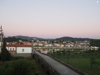 Fototapeta na wymiar Scenic summer sunset view of the old town and the bridge over the river in Ponte de Lima, Camino de Santiago, Way of St. James, Journey from Barcelos to Ponte de Lima, Portuguese way, Portugal