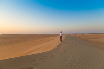 Fototapeta na wymiar UAE. Man in desert