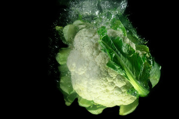 cauliflower dropping down in water with water bubbles and splashes under water cauliflower food...