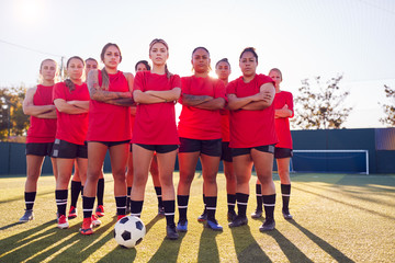 Portrait Of Womens Football Team Training For Soccer Match On Outdoor Astro Turf Pitch