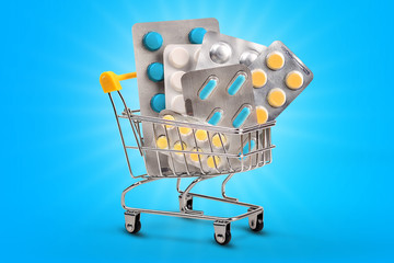 Mini shopping cart with pills and tablets isolated on color background