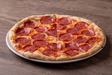 close up of tasty fresh baked salami pizza