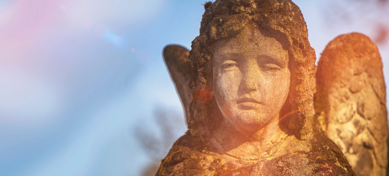 Beautiful sad angel. Vintage styled image of ancient stone statue. Religion, faith, death, resurrection, eternity concept.