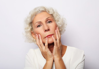 Thoughtful serious senior woman feeling blue worried about problems