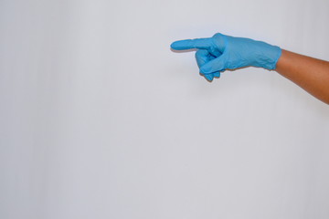 Hand in latex glove shows index finger