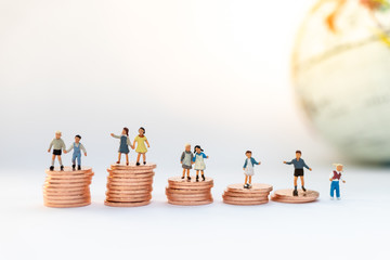 Miniature people: Children standing on top of stacked coins . Image use for background , Life insurance concept, Fund for education