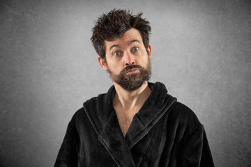 Man in bathrobe with funny hair funny face isolated background