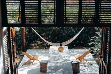 Concrete table and hammocks in the house among the jungle
