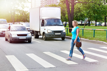 Woman crossing street at crosswalk