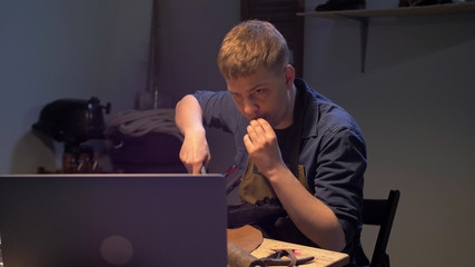 Man watches training video in the workshop