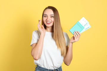 Beautiful young smiling girl holds tickets for travel. Rest, travel, tour.