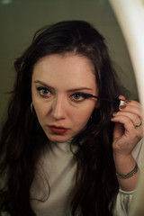 Obraz premium Close up portrait. Women make up eyes, lips at home by the mirror