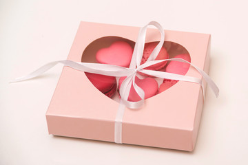 French cookies macaroons in a paper box. Delivery gift box with macarons. Valentines day...