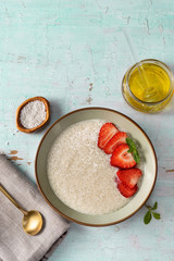 Vertical shot of a plate wiht vegan tapioca pudding on light turquoise background