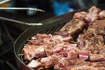 Barbeque, BBQ concept. Cooking grilled pork ribs. Food catering, party. Chef preparing meat on the grill. Street food.