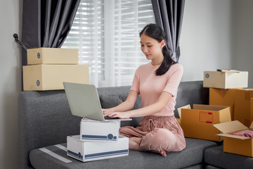 Happy beautiful girl who works at home About Online Business, Prepare goods to customers.