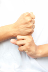 Shot of pair of human hands doing Vajra Yoga Mudra isolated on white background. Vertical shot of...