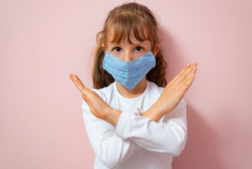 Coronavirus and Air pollution concept. Little girl wearing mask for protect  and show stop hands gesture for stop corona virus outbreak. Coronavirus and epidemic virus symptoms..