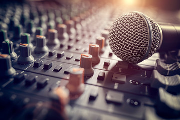 Sound recording studio mixing desk with microphone on mixer