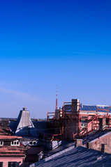 Lonely tower far away. through roofs of old buildings. 