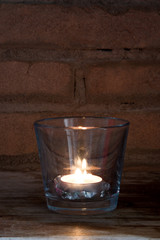 condelam lit in a glass cup