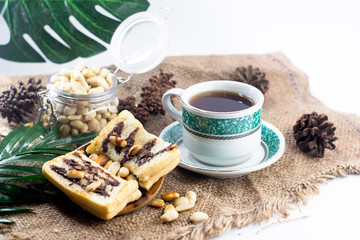 Continental breakfast with toast bread, peanuts and coffee or tea