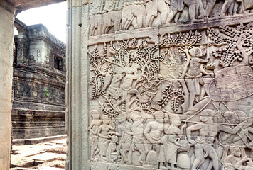 Ancient relief with fruit garden and harvesting people on wall of the 12th century Bayon temple, Cambodia. Historical place in Angkor. UNESCO world heritage site.
