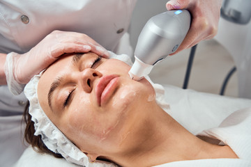 ultraformer lifting. Face Skin Care. Close-up Of Woman Getting Facial Hydro Microdermabrasion...