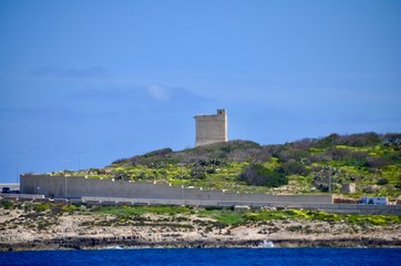 Fototapeta na wymiar Stone watch tower fortification overlooking St Paul's bay in Malta