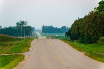 Rolling asphalt country road in the midwest town of Dexter Minnesota USA