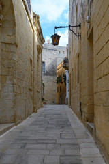 View of one of the many ancient narrow medieval streets in the  town of Mdina, Malta