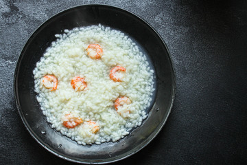 risotto shrimp prawn seafood rice Menu concept. food background. top view copy space for text keto or paleo diets