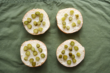 burger sesame buns cut in half with pickled cucumbers