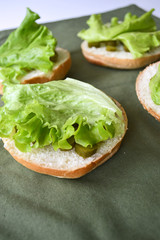 sesame burger rolls with pickled cucumbers and lettuce