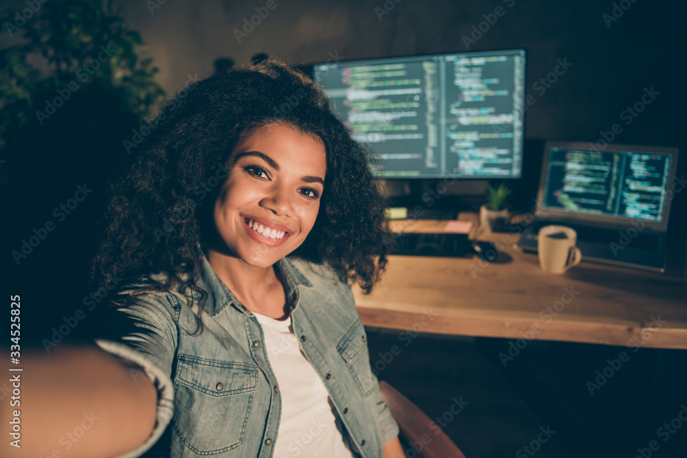 Poster positive joyful afro american girl web designer sit late evening office make self portrait show her 