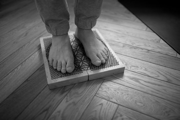 The yogi's feet are on nails. Healthy lifestyle.