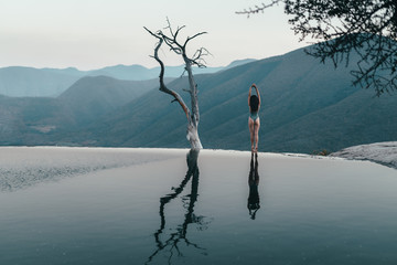 Girl on top of a white mountain with blue lakes and springs