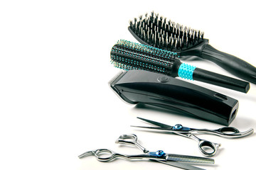 scissors, hair clipper and combs on white background.