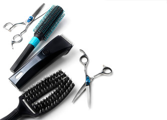 scissors, hair clipper and combs on white background.