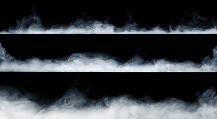 Panoramic view of the abstract fog or smoke move on black background. White cloudiness, mist or...