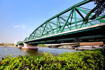 A beautiful old green bridge with steel structures.