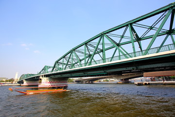 A beautiful old green bridge with steel structures.