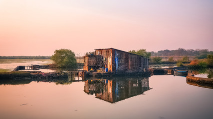 Reflection of hut  during sunset on the river