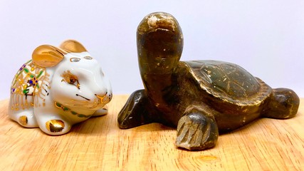 Close up, white rabbit amulet and black turtle amulet is a souvenir and a lucky thing put on a...