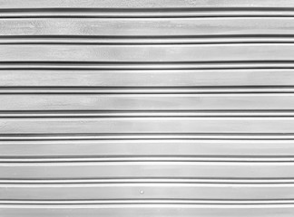 Obraz premium Texture background rolling shutters is a gray iron door retractable which has straight line pattern, glossy surface and new condition.