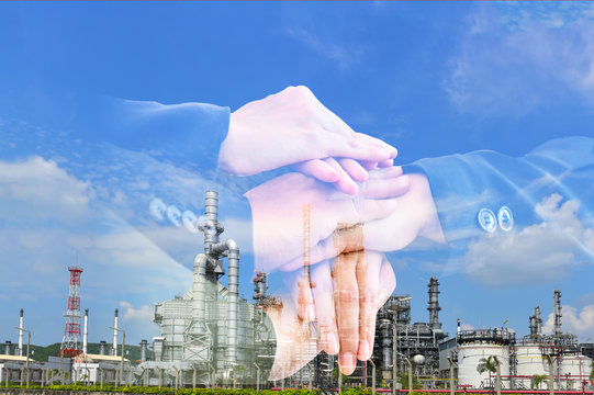 douple exposure handschake for invesment industry concept on oil refinery and storage tanker background