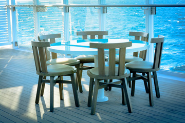 The empty table and chairs on the terrace with sea views
