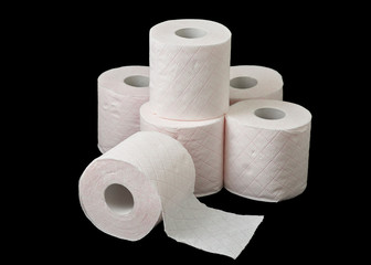 rolls of toilet paper piled on black background