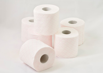 toilet paper rolls piled on white background