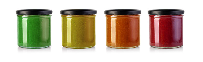 Jars of fruity jams isolated on white background. Preserved fruits